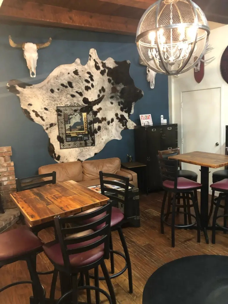 Tables and couch at Last Call: private events room at Swallow's Inn